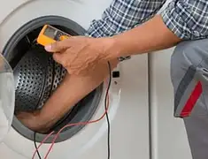 Washing machine repair technician testing a front-load washer with diagnostic tools in Santa Ana, CA