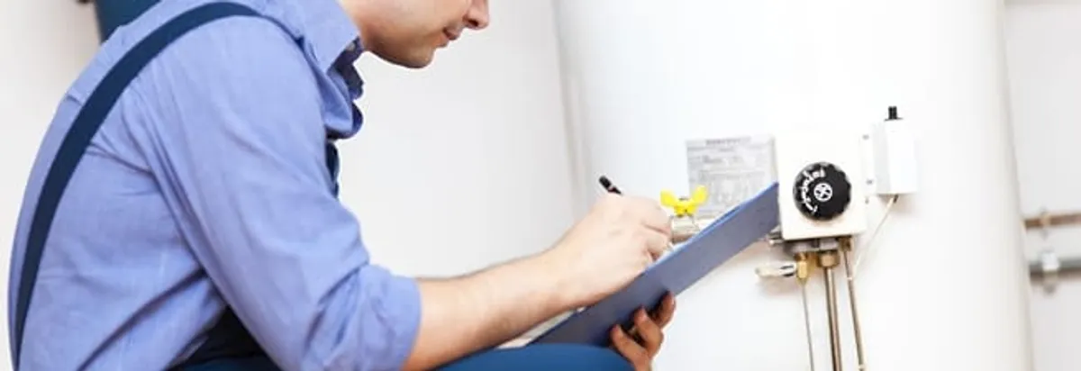 Water heater repair technician inspecting the unit and recording service notes in Santa Ana, CA